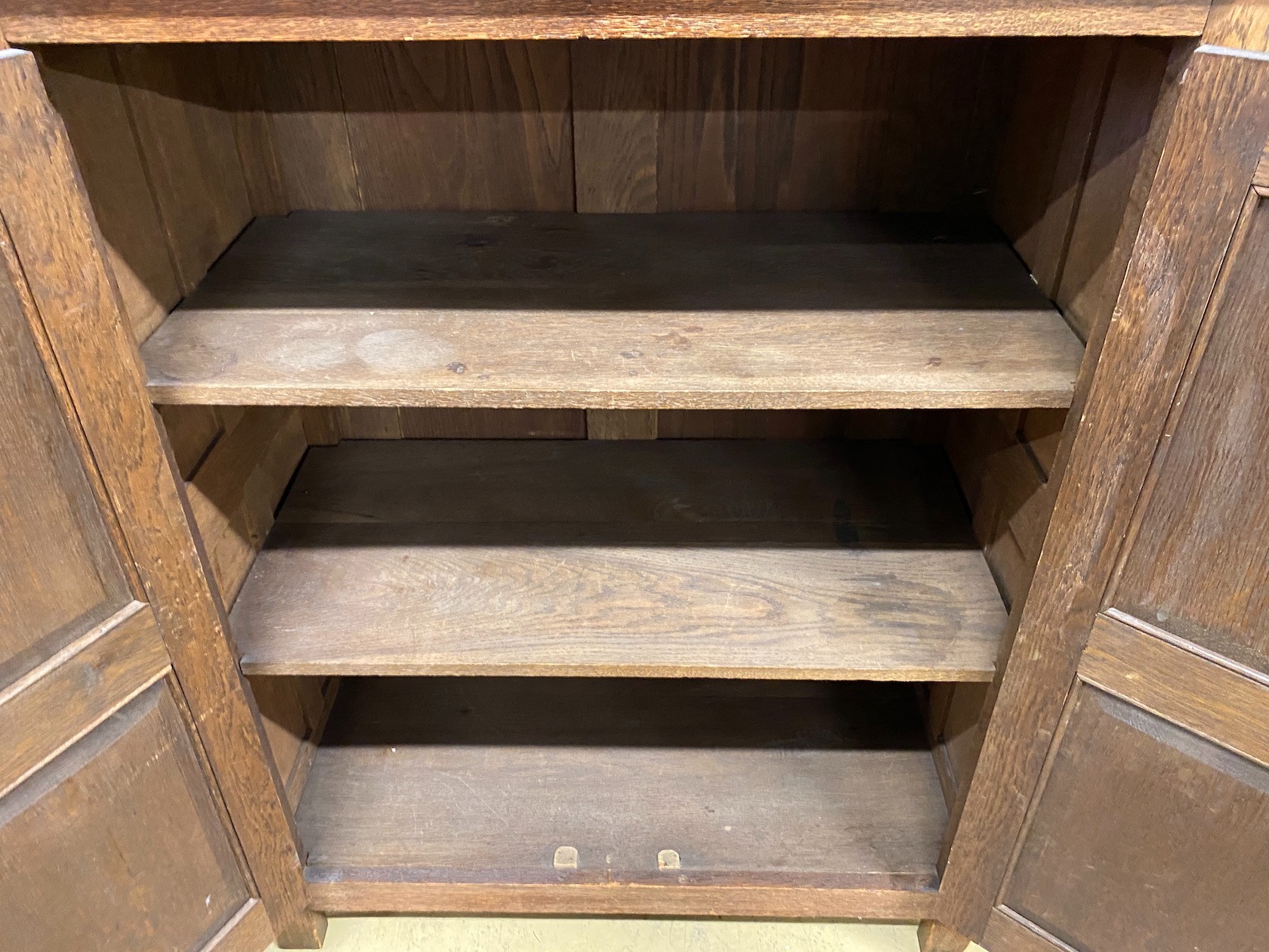 A reproduction oak linenfold moulded two door side cabinet, width 91cm, depth 49cm, height 114cm